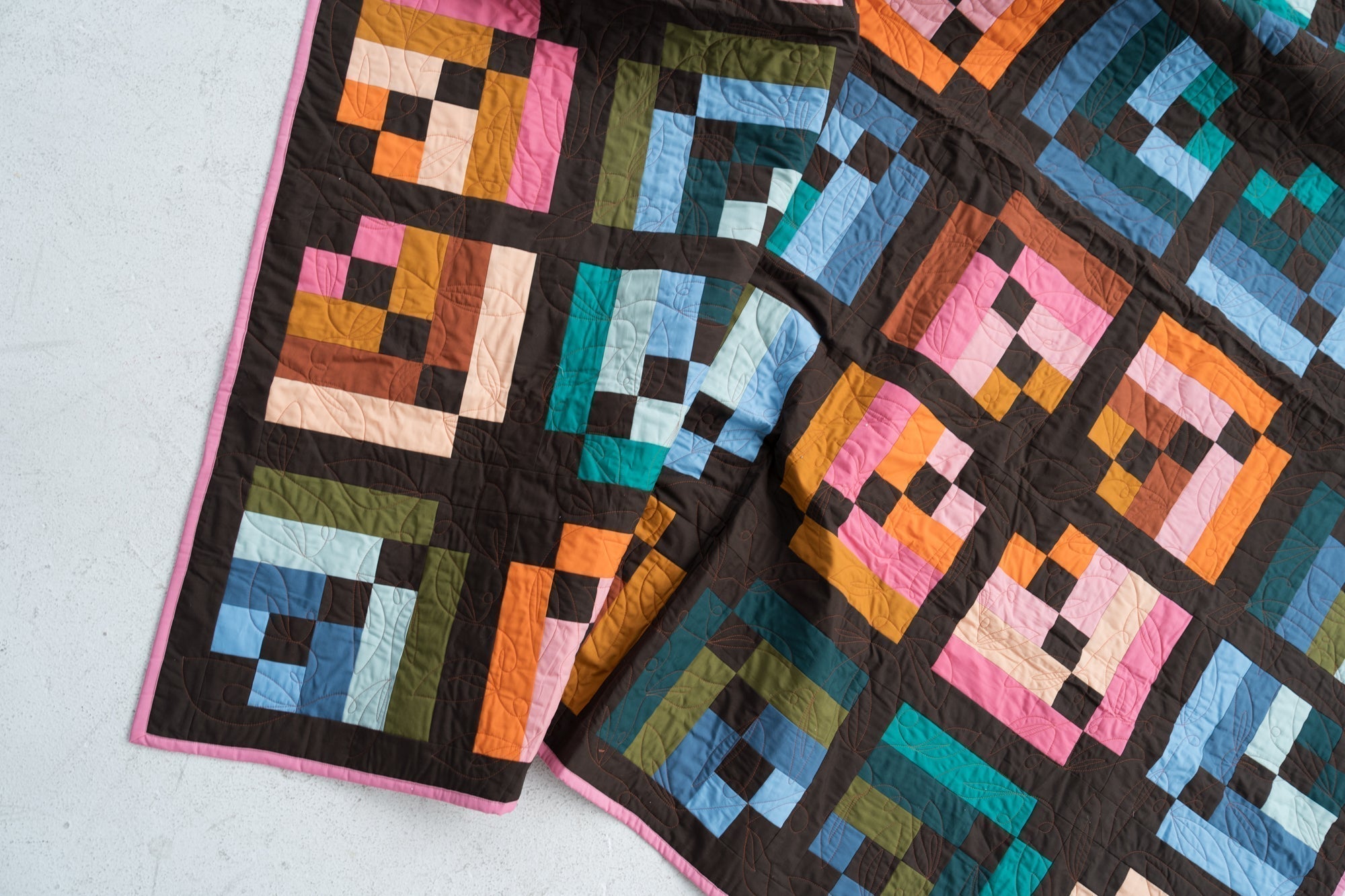Toad & Sew Intertwined PDF modern quilt pattern detail – close‑up of multicolor stacked stripe blocks and chocolate brown sashing
